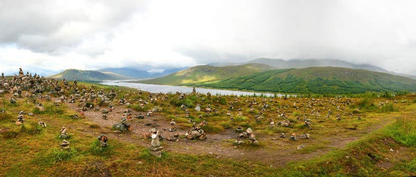 Small piles of stones made by tourists on viewpoint overlooking 