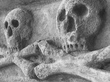 Ancient stone skull with crossbones
