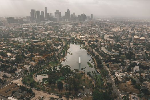 Echo Park in Los Angeles with View of Downtown Skyline and Foggy Polluted Smog Air in Big Urban City