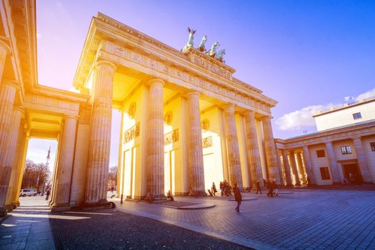 BERLIN, GERMANY - MARCH 24, 2017: people admire Brandenburg Gate (Brandenburger Tor) in Berlin in late afternoon