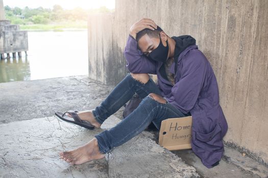 Unhappy homeless man under the bridge