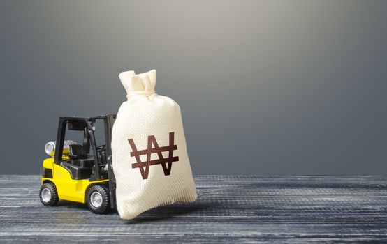 Forklift transports a south korean won money bag. Attraction of investments in business and economy, cheap loans, leasing. Borrowing on capital market. Stimulating economy. Crisis recovery measures.