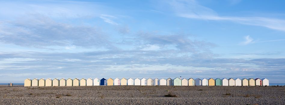 beach huts in cayeux s mer in french normandy under blue sky