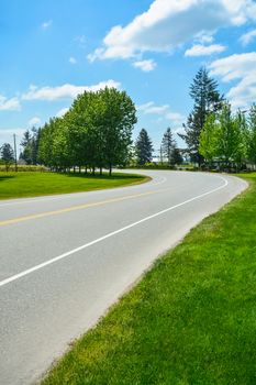Turn of asphalt road in rural area of Fraser Valley in British Columbia.