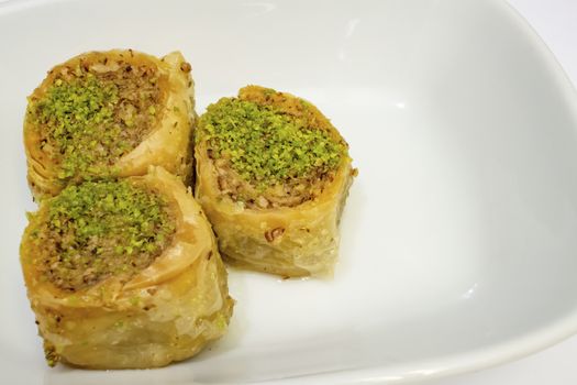 turkish baklava in the form of rolls with pistachio