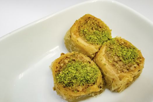turkish baklava in the form of rolls with pistachio