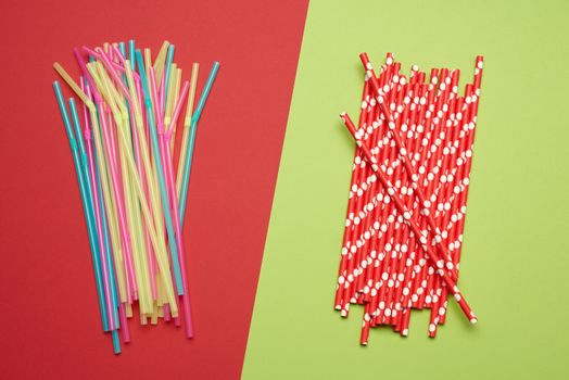 paper colorful cocktail straws and stack of plastic straws on pi