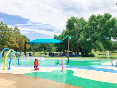 Modern splash park with shaded picnic areas for summertime activities near Dallas, Texas, America