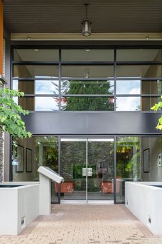 Entrance of new residential building with paved area in front
