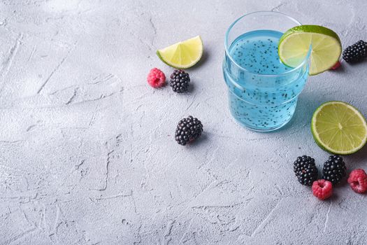 Tasty blue colored cocktail drink with basil chia seeds