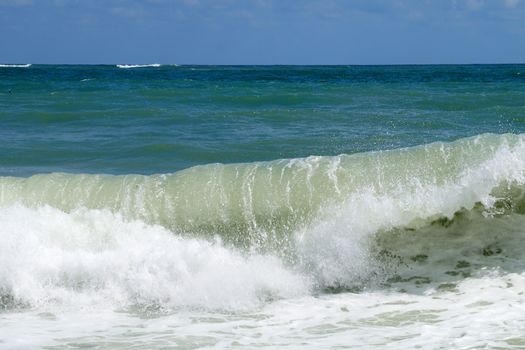 big white waves hitting the sea shore