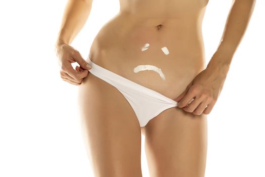 Skinny woman with sad expression on her belly