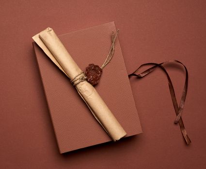 brown paper roll sealed with wax seal, top view