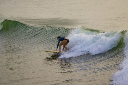 Chennai, Tamilnadu -India . September 2, 2020. A foreign lady tourists surfing the sea waves