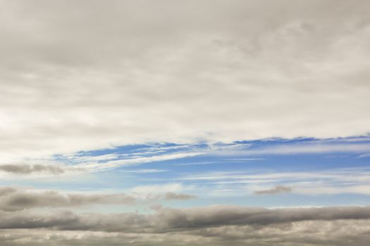 Blue streak in the cloudy sky. Sky panorama, Germany.