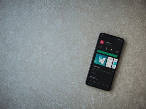 LG ThinQ app play store page on the display of a black mobile sm