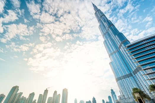 Burj Khalifa vanishing in blue sky in Dubai, UAE.