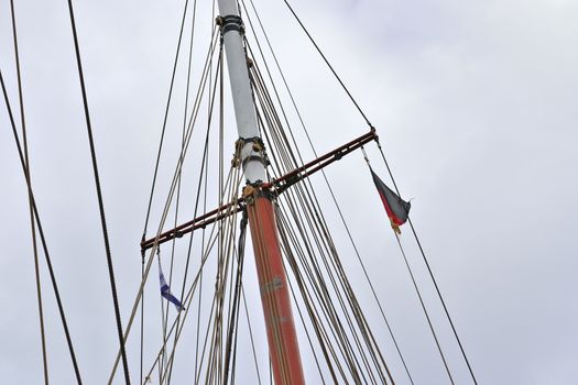 Sailing ship mast against the blue sky on some sailing boats wit