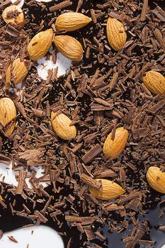 Almonds, grated and liquid chocolate on a white background
