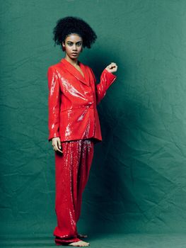 woman in a red suit full length curly hair decoration