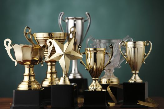 Group of the trophies on the green background