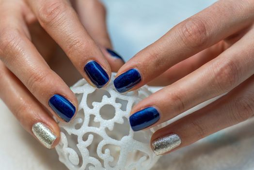 Beautiful female hands with blue manicure.