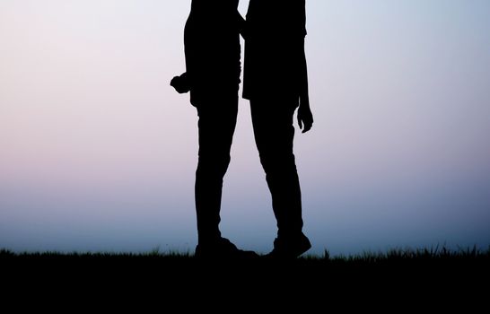 Couple on field with silhouette.