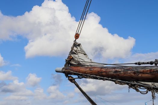 Sailing ship mast against the blue sky on some sailing boats wit