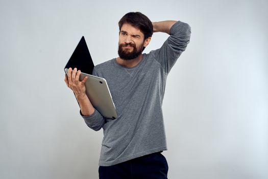 man holding laptop technology internet work communication light background. High quality photo