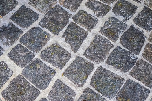 Detailed close up on old historical cobblestone roads and walkwa