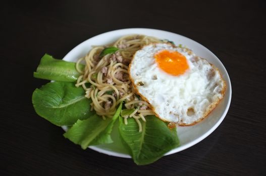 Spaghetti stir fried with Thai Basil spicy sauce with Fried egg  , fusion Thai style