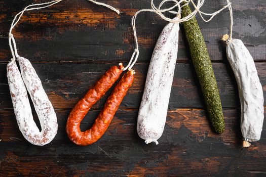 Dry cured fuet and other sausage s on wooden background
