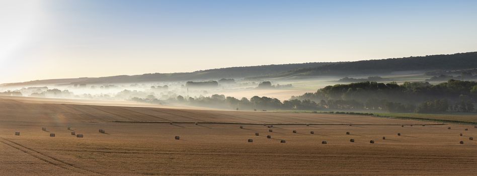 straw bales in early morning light on countryside of french normandy near calais and boulogne in parc naturel des caps et marais dopale