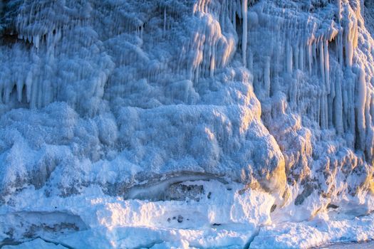 Blue ice stalactite on cliff, winter season in Siberia, Russia