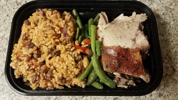 Puerto Rican pork and rice and beans in container