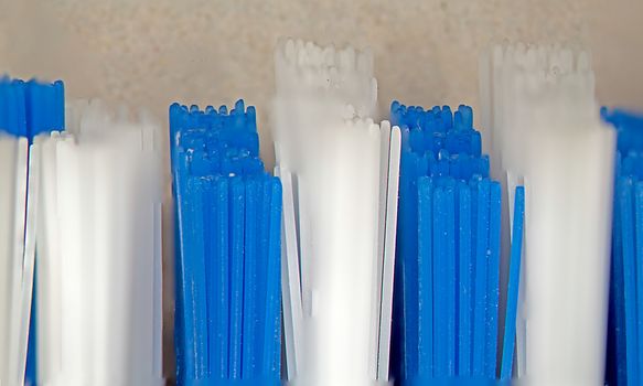 Toothbrush with blue white bristles in close up