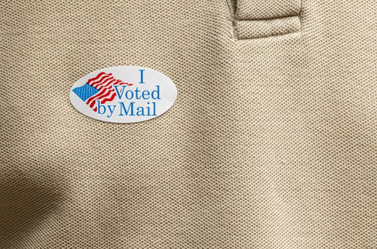 I Voted by Mail paper sticker on shirt to illustrate voting by mail in election
