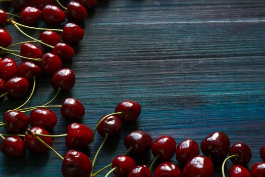 Fresh cherry on the table on wooden blue background. fresh ripe cherries. sweet cherries.