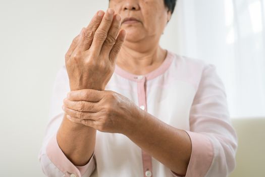 wrist hand pain of old woman, healthcare problem of senior conce