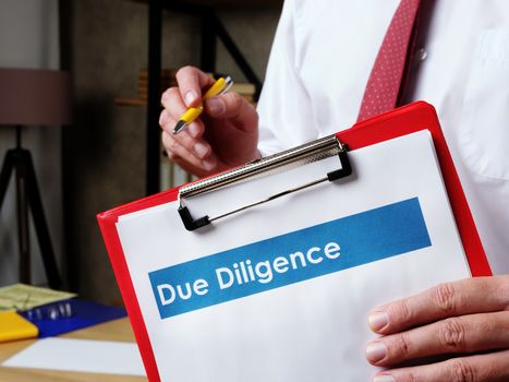 Due diligence documents in the hands of a young clerk.