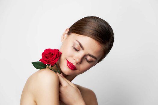 Portrait of woman with rose Eyes closed red lips