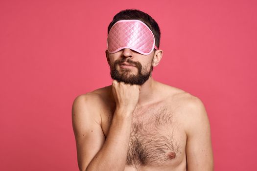 man with head massager relax body care pink background