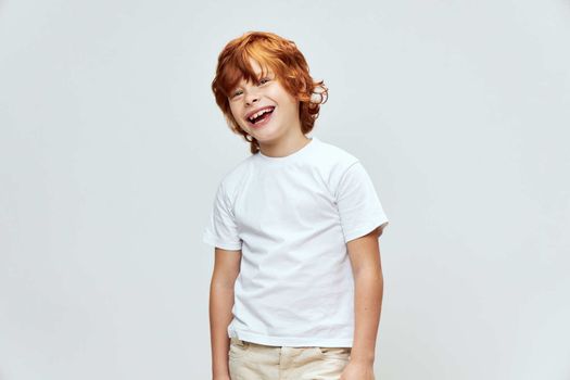 Joyful child white t-shirt wide open smile cropped view white t-shirt studio