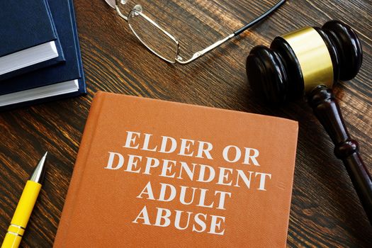 Elder or dependent adult abuse book and gavel.