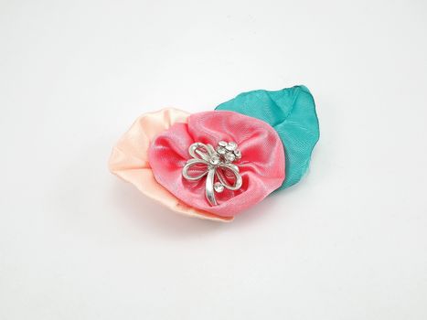 Floral fabric with metal ribbon brooch