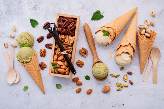 Pistachio and vanila ice cream in cones  with mixed nut setup on