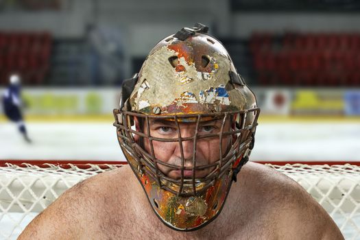 Hockey goalie in the mask. Goalkeeper in an old hockey mask