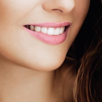 Beautiful healthy female smile with perfect natural white teeth, beauty face closeup of smiling young woman, bright lipstick makeup and clean skin for dental and healthcare brands
