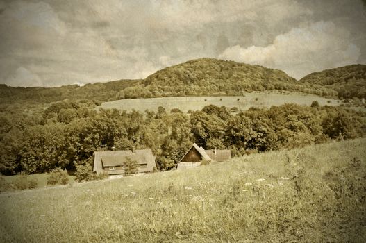 country idyll with old farmhouse and hill