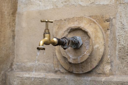 Urban fountain tap, detail of water for human consumption